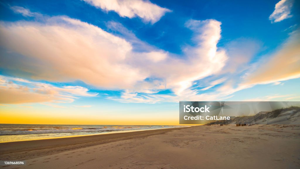 Big sky over sandy beach and ocean in North Carolina. Outer Banks at sunrise North Carolina - US State Stock Photo