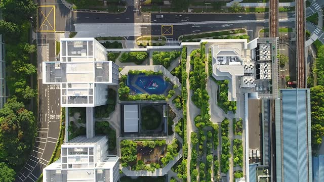 Aerial drone shot flying over public housing with roof garden in Singapore