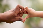 istock Shot of an unrecognisable man and his child making a heart shaped gesture with their hands in a garden 1369672541