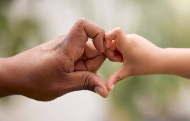 Shot of an unrecognisable man and his child making a heart shaped gesture with their hands in a garden The littlest people take up the biggest room in your heart affectionate stock pictures, royalty-free photos & images