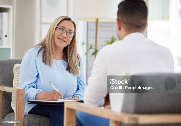 Shot Of A Mature Psychiatrist Sitting With Her Patient During A Consultation In Her Clinic Stock Photo - Download Image Now