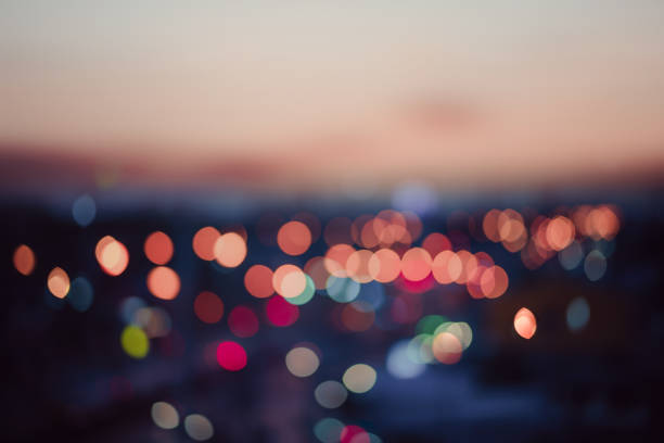 istock Evening view of abstract bokeh lights is blurred with the dramatic sky and clouds at dusk. 1369686151