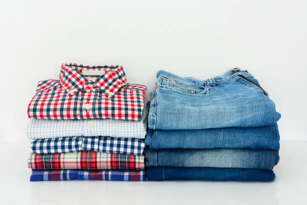 istock stack of plaid shirts and jeans isolated on white background 1369687415