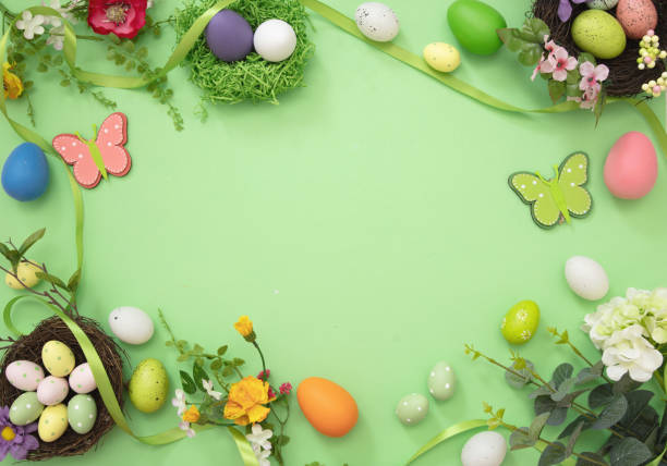 istock Easter flat lay. Egg nest, flower and decoration pastel green background, overhead, space. 1369689700