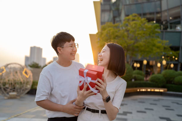 Happy couple opening a box and looking inside to product