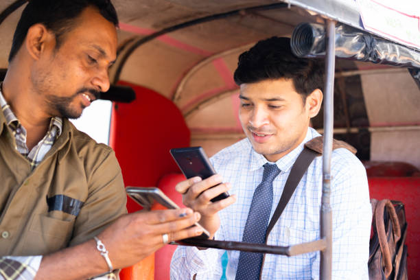 Auto rickshaw or cab passenger paying money by scanning qr code on mobile phone - concept of digital or online contactless payment and secure wireless transaction Auto rickshaw or cab passenger paying money by scanning qr code on mobile phone - concept of digital or online contactless payment and secure wireless transaction. auto rickshaw taxi india stock pictures, royalty-free photos & images