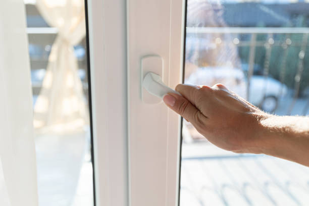 istock Young woman opens white window with sunlight at home. 1369696359