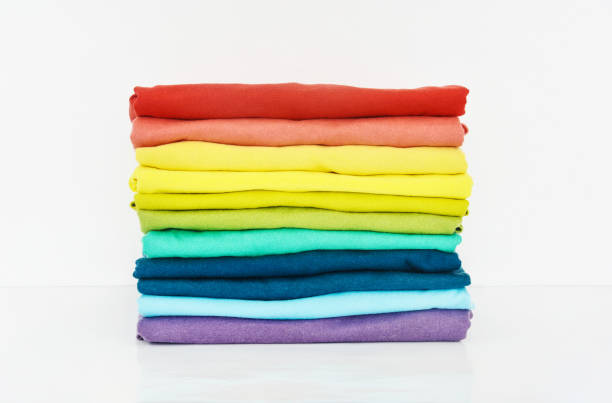 istock stack of colorful t-shirt on white background 1369696731