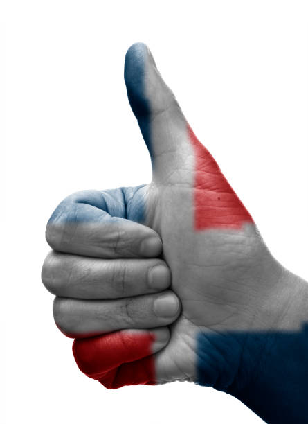 Human hand doing the thumbs up sign isolated on white with the dominican republic flag painted on it. You can also use it as a thumbs down just rotating it 180º