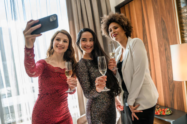 istock Charming Ladies In Party Dresses Taking A Selfie 1369700433