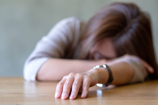 istock A young woman get tired and asleep on the table 1369700627