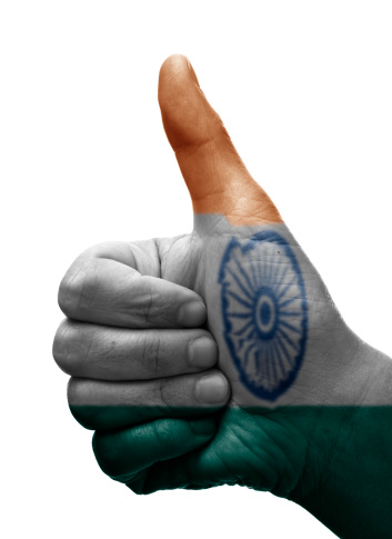 Human hand doing the thumbs up sign isolated on white with the indian flag painted on it. You can also use it as a thumbs down just rotating it 180º