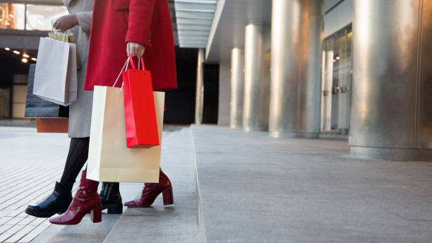 istock women's legs going down the stairs at the exit of the store 1369701144