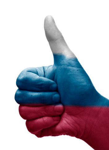 Human hand doing the thumbs up sign isolated on white with the russian flag painted on it. You can also use it as a thumbs down just rotating it 180º