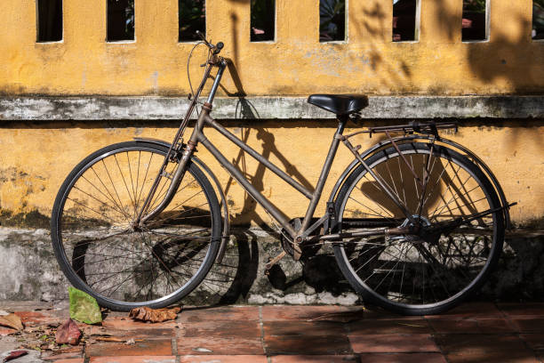 istock Old bicycle lane on yellow old wall with natural light 1369703265
