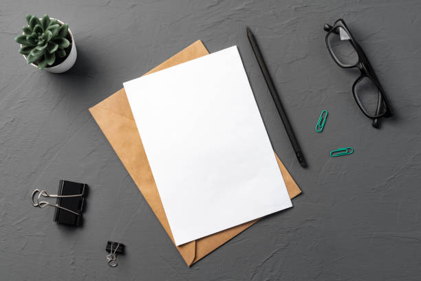 istock Letters and Office Supplies on Table Desk. Top View 1369705249