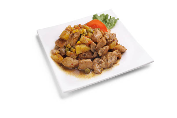 Chicken curry with vegetables on a white plate isolated on white background