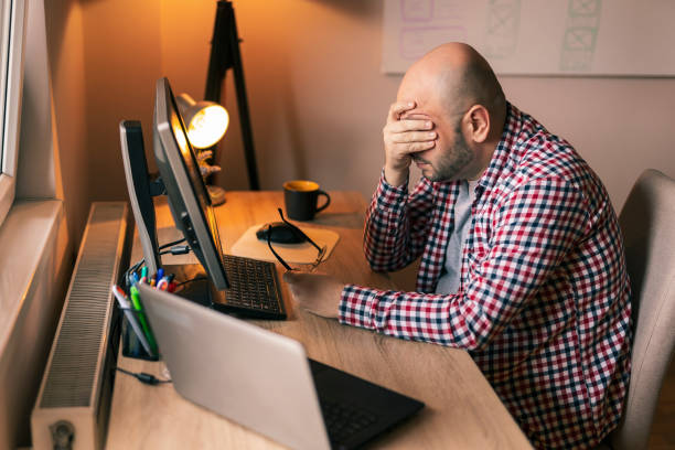Web developer stressed out at work stock photo