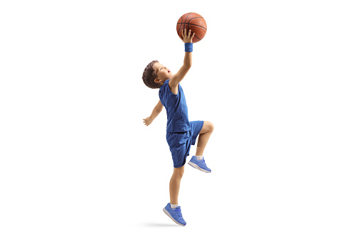 Male african american basketball player throwing ball in hoop while training at indoor sports court