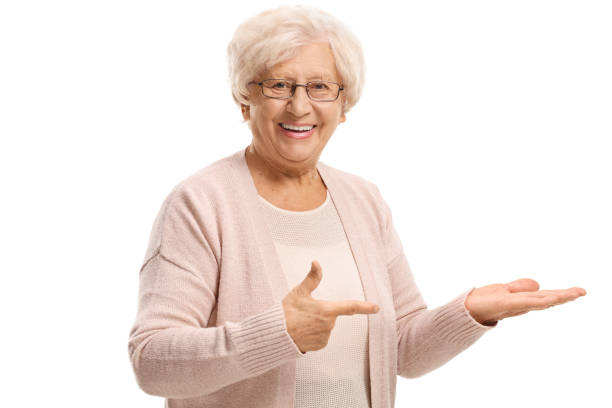 istock Smiling elderly woman pointing at her hand 1369709060