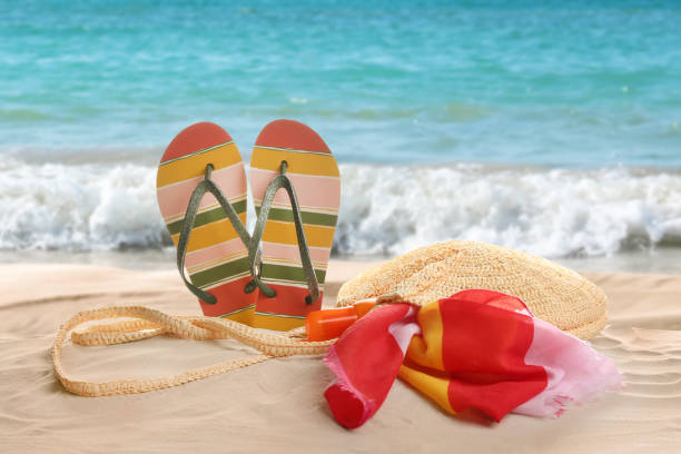 istock Different beach accessories on sand near ocean 1369709628