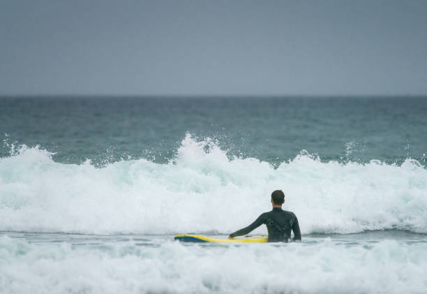 istock Young man surfing off the Cornish Coast 1369709703