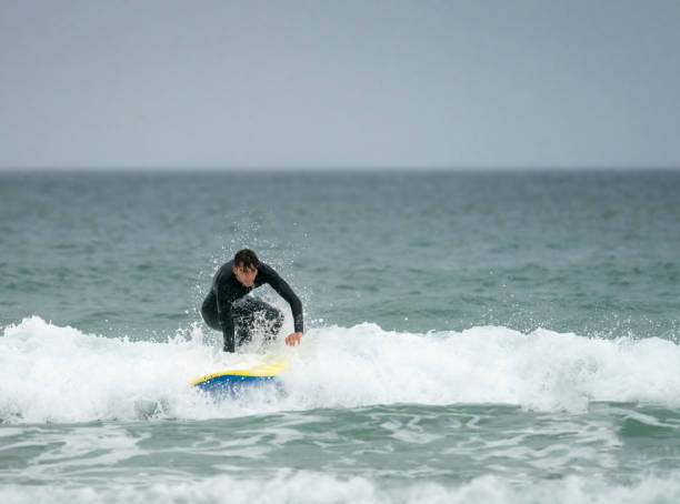 istock Young man surfing off the Cornish Coast 1369709715