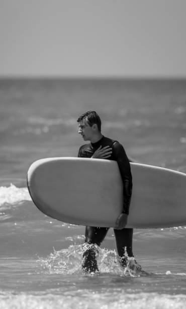 istock Young man surfing off the Cornish Coast 1369709770