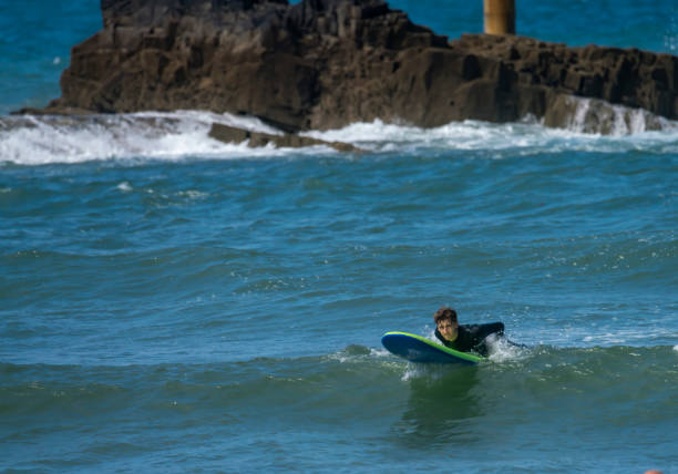 istock Young man surfing off the Cornish Coast 1369709780