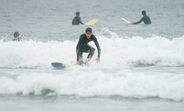 istock Young man surfing off the Cornish Coast 1369709867