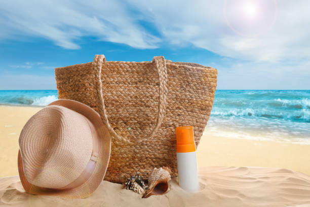istock Different beach accessories on sand near ocean 1369710913