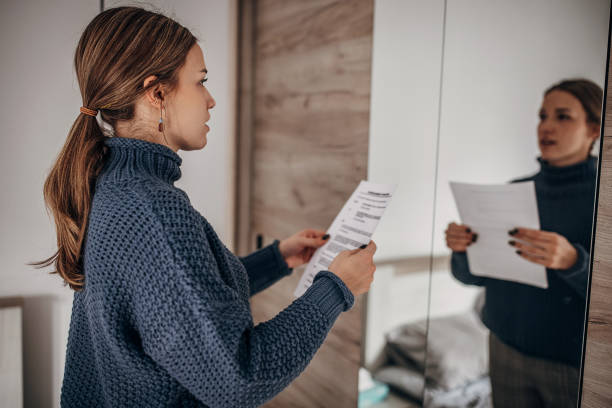 Woman rehearsing speech One woman, beautiful woman rehearsing a speech in bedroom mirror at home. speech stock pictures, royalty-free photos & images