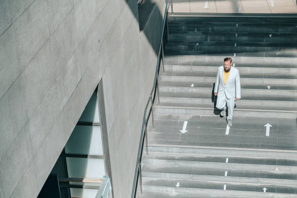 senior business man coming down stairs
