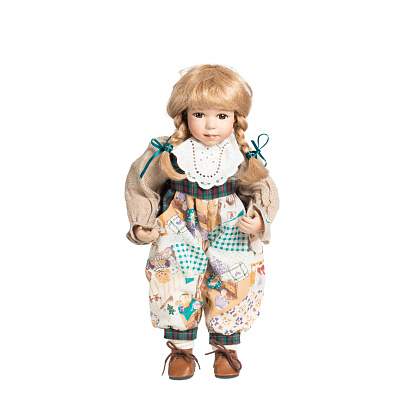 Amazing realistic vintage toy with brown eyes.The doll dressed in a beige suit and has a blond hair. Selective focus. Porcelain doll.