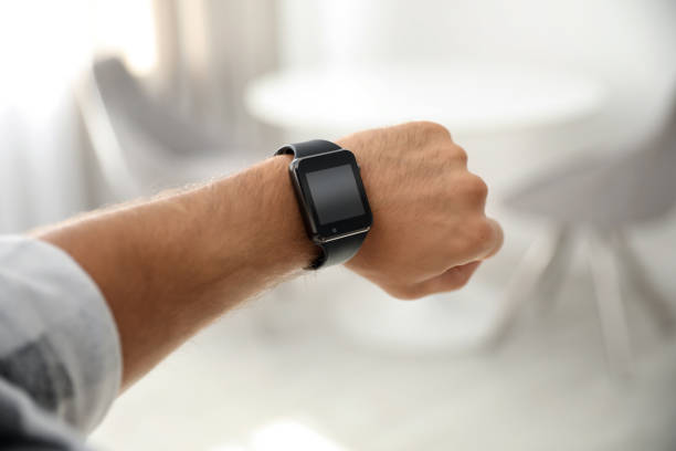 istock Man with smart watch on blurred background, closeup 1369713633