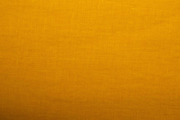 istock Natural linen fabric texture. Textured yellow fabric background. Concept of using natural eco-friendly materials 1369714969