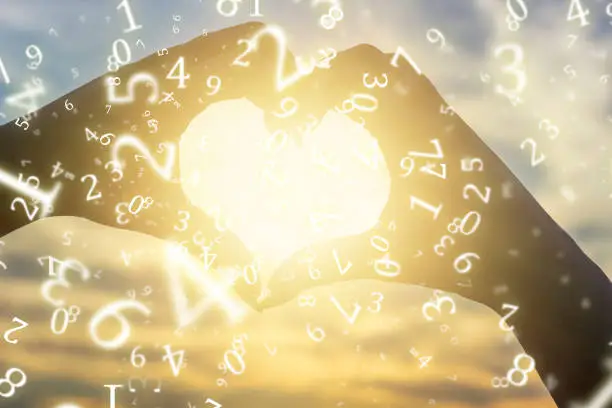 numerology, a young girl folded her hands in the shape of a heart against the background of the sun at sunset, surrounded by numbers