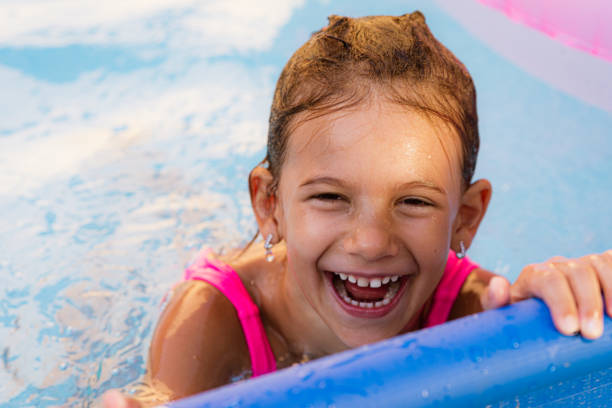 istock Children games in swimming pool 1369718088