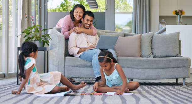 istock Shot of two sisters playing together while their parents relax together 1369718100