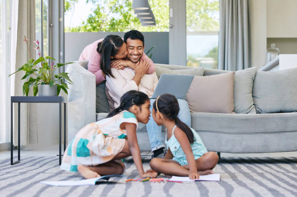 istock Shot of two sisters playing together while their parents relax together 1369718105