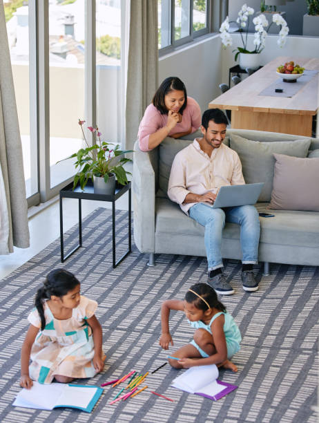 istock Shot of two sisters drawing while their parents relax together 1369718146