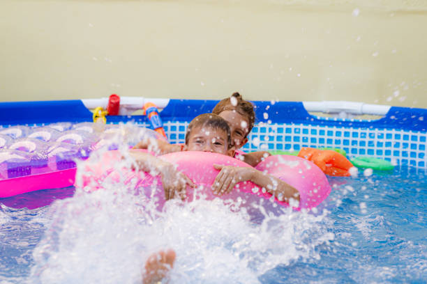 istock Children games in swimming pool 1369718253