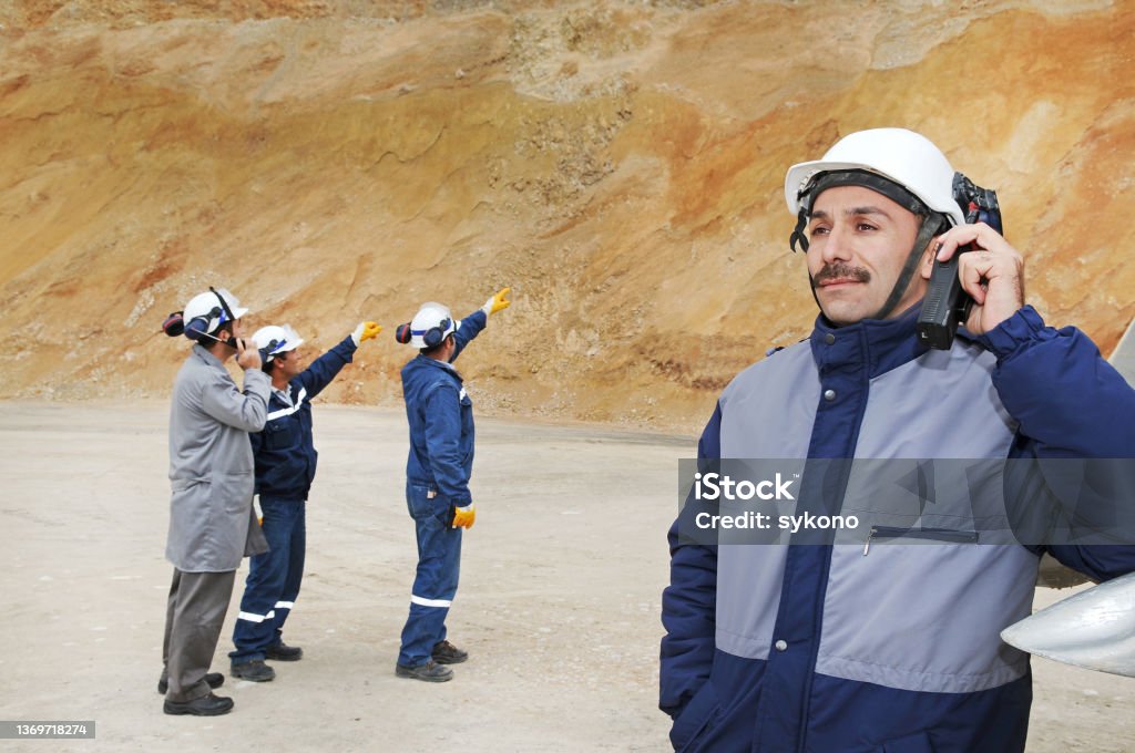 Workman Solving Problem Group Of Workers Solving Problem At A Quarry Stock Photo - Download ...