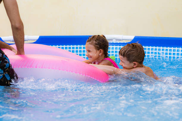 istock Children games in swimming pool 1369718380