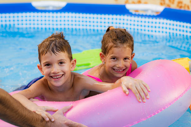istock Children games in swimming pool 1369718531