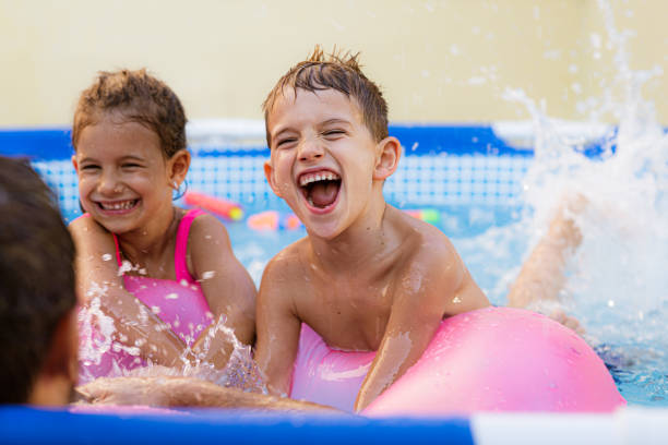 istock Children games in swimming pool 1369719370