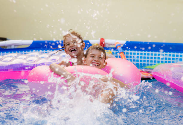 istock Children games in swimming pool 1369719419