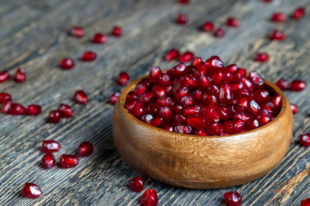 istock scattered pomegranate seeds on a wooden board 1369719459
