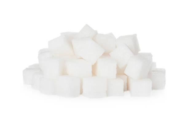 istock Heap of refined sugar cubes on white background 1369719948