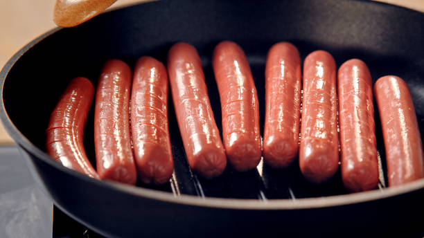 istock Fried sausages in a pan on the stove. 1369720943